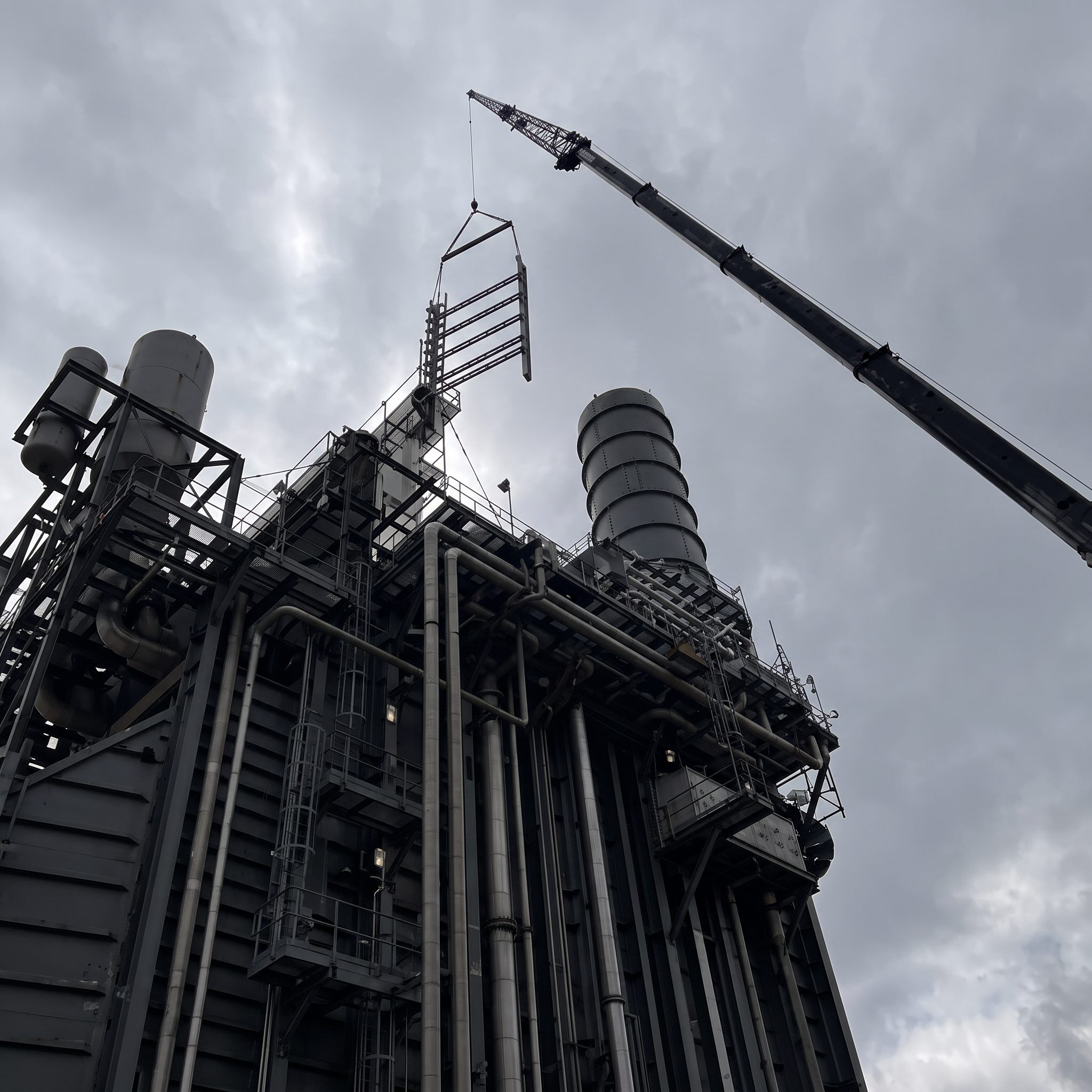 Industrial steel structure with a crane on site