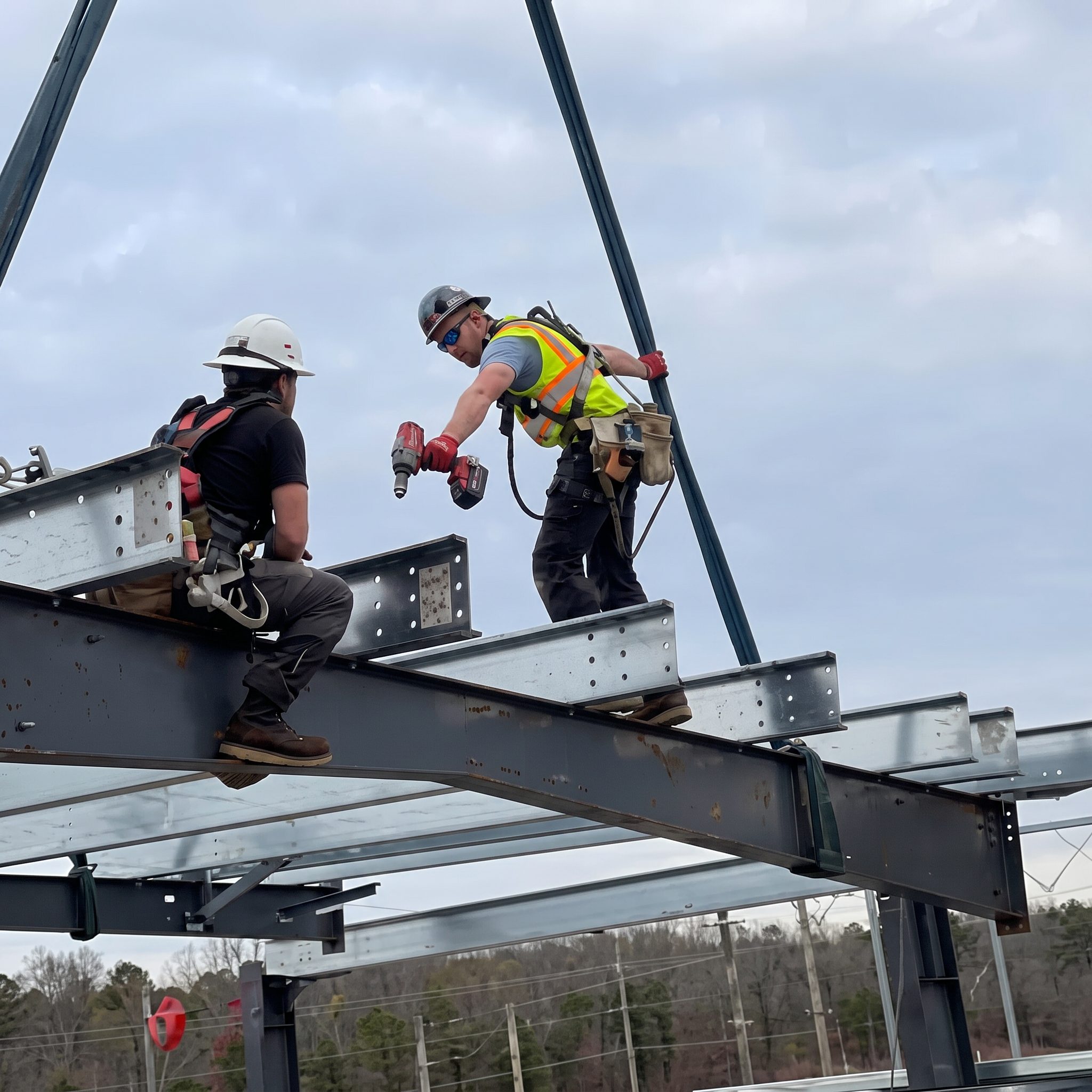 Crew rigging and setting a steel beam at height